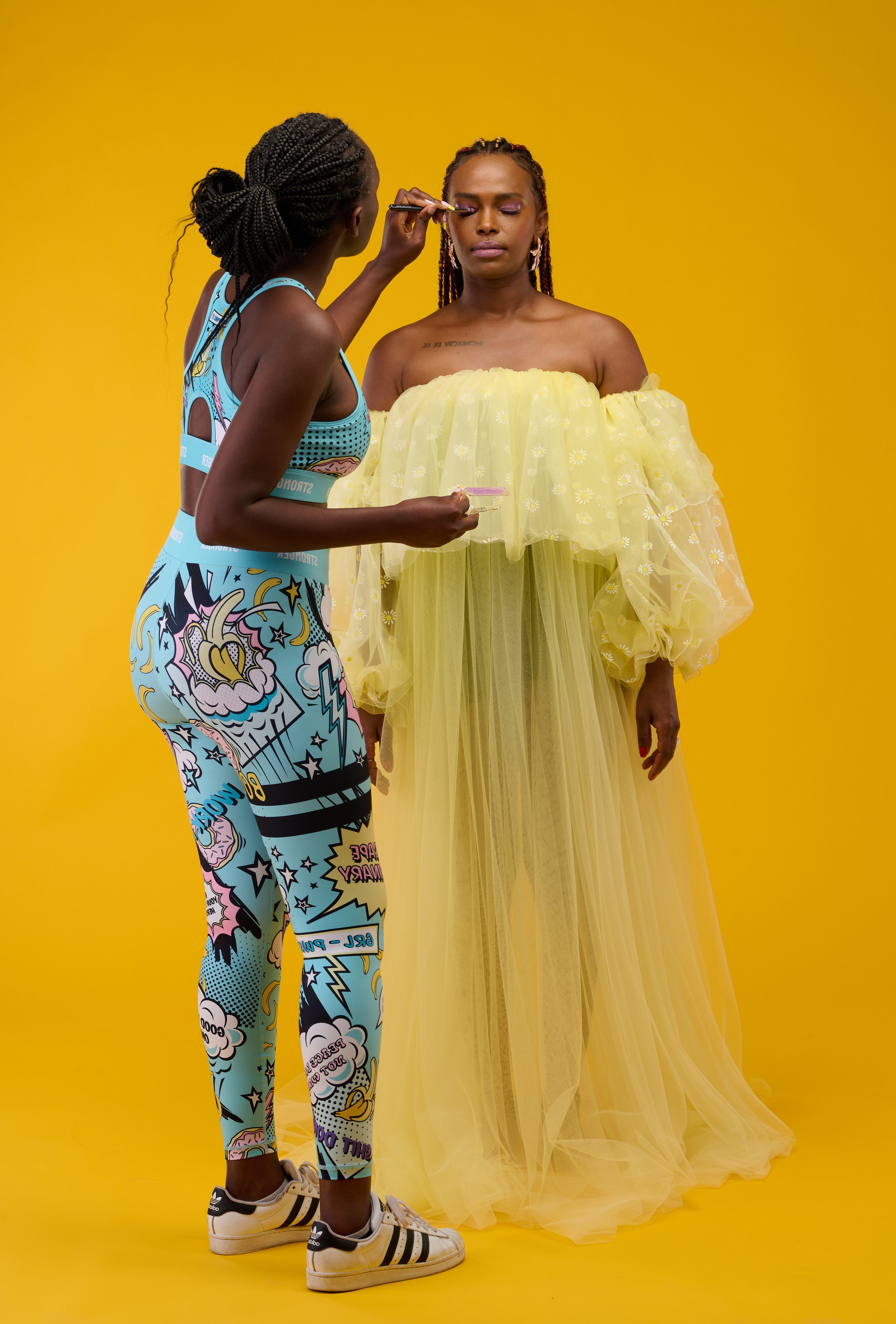 Makeup artist making touch-ups on model